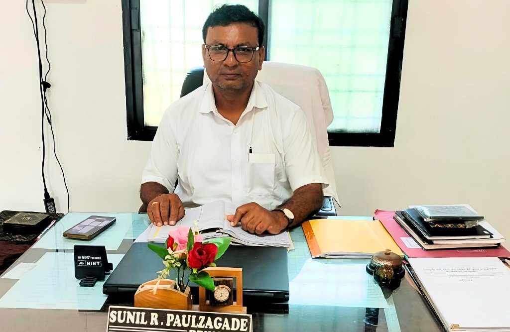 Principal Sunilkumar Ramkrushna Paulzagade at his office desk